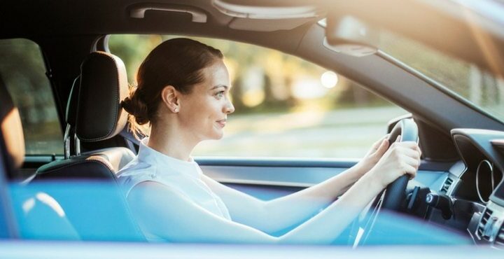 A woman is driving a car.