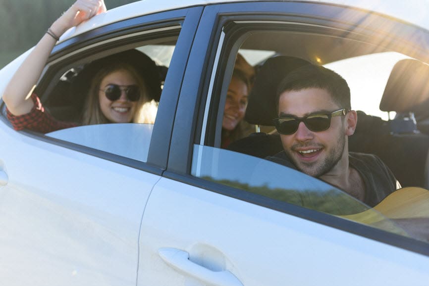Happy group of friends in car