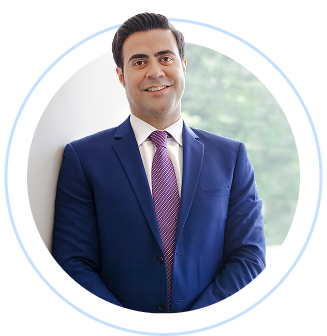 A person in a suit and tie smiles.